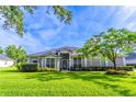 Beautiful single-story home with manicured lawn and lush landscaping at 2538 Carter Grove Cir, Windermere, FL 34786