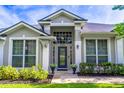Welcoming front entrance with decorative glass door, sidelights and manicured landscaping at 2538 Carter Grove Cir, Windermere, FL 34786