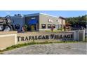 Trafalgar Village entrance with retail shops, offering convenient amenities and a welcoming atmosphere at 2545 Old Kent Cir, Kissimmee, FL 34758