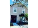 Inviting exterior showcases accessibility features and tropical landscaping, with decorative windows and a covered entryway at 2545 Old Kent Cir, Kissimmee, FL 34758