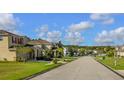 Picturesque street view featuring well-manicured lawns and a variety of attractive homes in a tranquil neighborhood at 2545 Old Kent Cir, Kissimmee, FL 34758