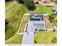 Aerial view of a beautiful home with a solar panel roof, screened-in pool, and fenced yard at 2832 Buccaneer Dr, Winter Park, FL 32792