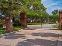 Gated entrance to the community with brick pillars, providing privacy and security at 2880 Old Castle Dr, Winter Park, FL 32792