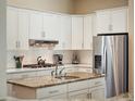 Well-equipped kitchen with stainless steel appliances, granite countertops, and white cabinetry at 2880 Old Castle Dr, Winter Park, FL 32792