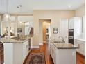 Spacious kitchen with granite countertops, double sinks, hardwood floors and stainless appliances at 2880 Old Castle Dr, Winter Park, FL 32792