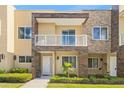 Charming two-story townhome features a private balcony, stone accents, and welcoming curb appeal at 3149 Brasilia Ave, Kissimmee, FL 34747