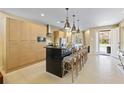 Modern kitchen features a large island with seating, stainless steel appliances, and sleek cabinetry at 3149 Brasilia Ave, Kissimmee, FL 34747