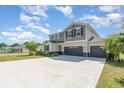 Spacious two-story home featuring a three-car garage, well-kept lawn and a large driveway at 31792 Broadwater Ave, Leesburg, FL 34748