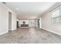 Inviting living space showcasing tile floors and an open view of the kitchen and sliding doors at 31792 Broadwater Ave, Leesburg, FL 34748