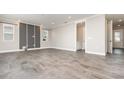 Open-concept living area with modern tile flooring, neutral paint and doorway to a half bathroom at 31792 Broadwater Ave, Leesburg, FL 34748