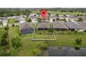 Aerial view of a beautiful property with a well-maintained yard and a serene lake view at 3349 Sagebrush St, Harmony, FL 34773