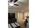 Bright living room with a large television, surfboard, and bar with a countertop at 3417 Westchester Square Blvd # 202, Orlando, FL 32835