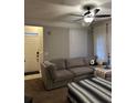 Inviting living room featuring a comfortable gray sectional couch and bright natural light from large windows at 3417 Westchester Square Blvd # 202, Orlando, FL 32835