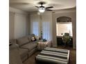 Cozy living room with built-in desk, lots of natural light, and a comfortable gray sectional at 3417 Westchester Square Blvd # 202, Orlando, FL 32835