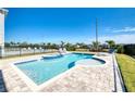 Backyard pool features a built-in spa, sun shelf, and lounge chairs on a brick patio at 408 Southfield St, Kissimmee, FL 34747