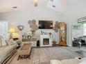 Bright living room features a fireplace, vaulted ceilings, and neutral decor at 439 Lake Daisy Dr, Winter Haven, FL 33884