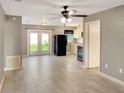 Open living space with tile floors, ceiling fan and access to the kitchen at 49 Orange Park Blvd, Lake Wales, FL 33898