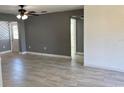 Open living room features neutral paint, tiled flooring and access to other rooms at 49 Orange Park Blvd, Lake Wales, FL 33898