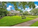 Attractive two-story home with well-maintained lawn and mature trees offers beautiful curb appeal at 614 Lake Ave, Orlando, FL 32801