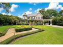 Beautiful home features a well-kept lawn, lovely landscaping, and a charming walkway leading to the front entrance at 614 Lake Ave, Orlando, FL 32801