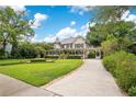 Charming two-story home with a lush green lawn, decorative landscaping, and a welcoming driveway at 614 Lake Ave, Orlando, FL 32801