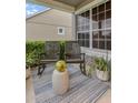 Cozy front porch featuring rocking chairs, a decorative rug, and potted plants for a relaxing outdoor space at 6527 Silver Queen Way, Windermere, FL 34786