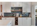 Stylish kitchen with a bar, modern appliances, wooden countertop, and a wine wrack at 719 Stevelynn Cir, Winter Garden, FL 34787