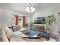 Bright living room with comfortable sectional, a bay window, stylish lighting, and contemporary decor at 719 Stevelynn Cir, Winter Garden, FL 34787