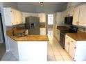 Bright kitchen featuring stainless steel appliances, granite countertops, and ample cabinet space at 8025 Old Town Dr, Orlando, FL 32819