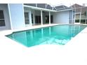 Relaxing in-ground swimming pool surrounded by a screened-in lanai for ultimate privacy and enjoyment at 8025 Old Town Dr, Orlando, FL 32819