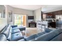 Inviting living room with contemporary furnishings, entertainment center, and sliding glass doors to a patio at 936 Calabria Ave, Davenport, FL 33897
