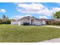 Charming single-story home with a well-maintained lawn, gray color scheme and attached two-car garage at 999 Trumbull St, Deltona, FL 32725