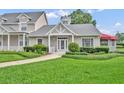 Inviting single-story home showcases lush landscaping and a welcoming front porch at 104 Nautica Mile Dr, Clermont, FL 34711