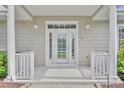 Inviting front door with sidelights, columns, and transom window, creating an elegant entrance at 104 Nautica Mile Dr, Clermont, FL 34711