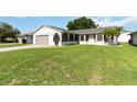 Well-manicured lawn leads up to this single-story home with a two-car garage at 11412 Stamfield Dr, Orlando, FL 32821
