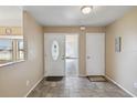Inviting foyer features tile flooring, a decorative front door, and neutral paint at 11412 Stamfield Dr, Orlando, FL 32821
