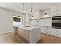 Bright kitchen with white cabinetry, a stylish island, and modern stainless-steel appliances at 1217 Cloverlawn Ave, Orlando, FL 32806