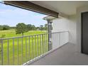 Relaxing balcony view with a golf course, lake, and blue skies at 13917 Fairway Island Dr # 931, Orlando, FL 32837