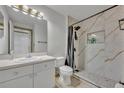 Modern bathroom featuring a walk-in shower with stylish marble-like tiling and a sleek vanity at 141 Reserve Cir # 113, Oviedo, FL 32765