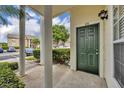 Inviting condo front door, number 113, with classic white columns, and a serene garden view at 141 Reserve Cir # 113, Oviedo, FL 32765