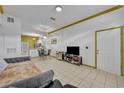 Open floor plan with tile flooring, a dining table, and a view into the well-lit kitchen at 141 Reserve Cir # 113, Oviedo, FL 32765