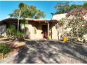 Stunning front exterior with paver driveway, mature landscaping, and a pergola detail at 1840 Laurel Rd, Winter Park, FL 32789