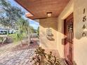 Cozy covered porch with unique plants, textured wall and convenient door access at 1840 Laurel Rd, Winter Park, FL 32789