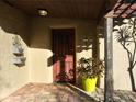 Covered front porch with a decorative door, textured walls, and paver flooring at 1840 Laurel Rd, Winter Park, FL 32789