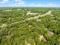 Aerial view of a property surrounded by lush greenery in a serene and private setting at 2 Rollingwood Trl, Deland, FL 32724