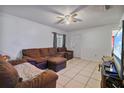 Living room with comfortable furniture, tiled flooring and a view of a large television screen at 229 Bitterwood St, Winter Springs, FL 32708