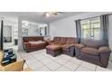 Cozy living room featuring a large window and comfortable brown seating, creating an inviting space at 229 Bitterwood St, Winter Springs, FL 32708