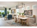 Open-concept living and dining area with ample natural light and elegant decor at 2500 Raghav Trail Cir, Tavares, FL 32778