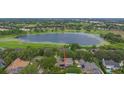 Aerial view of the property showcasing its prime location on a lake with lush green surroundings at 3372 Bellington Dr, Orlando, FL 32835