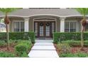 Attractive front entrance with a double door entry and well-manicured hedges and landscaping at 3372 Bellington Dr, Orlando, FL 32835